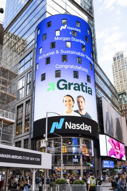 The Nasdaq tower in Times Square displaying "Nasdaq and Morgan Stanley Inclusive and Sustainable Ventures, congratulations Gratia" with the Gratia logo and founders' photo.
