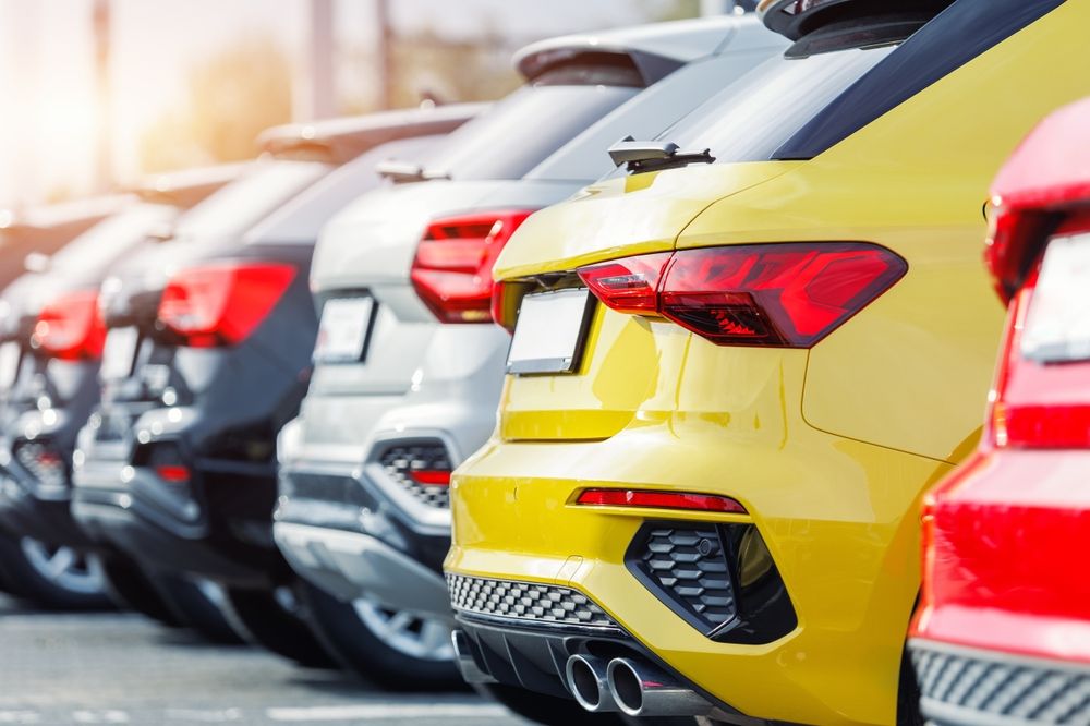 Row of used cars lined up at a dealership, representing car shopping and potential risks of buying a defective vehicle