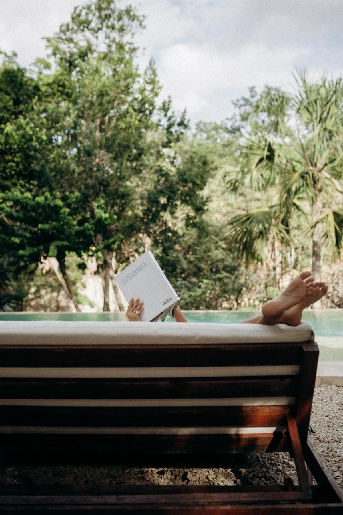 Guest relaxing poolside at a luxury villa