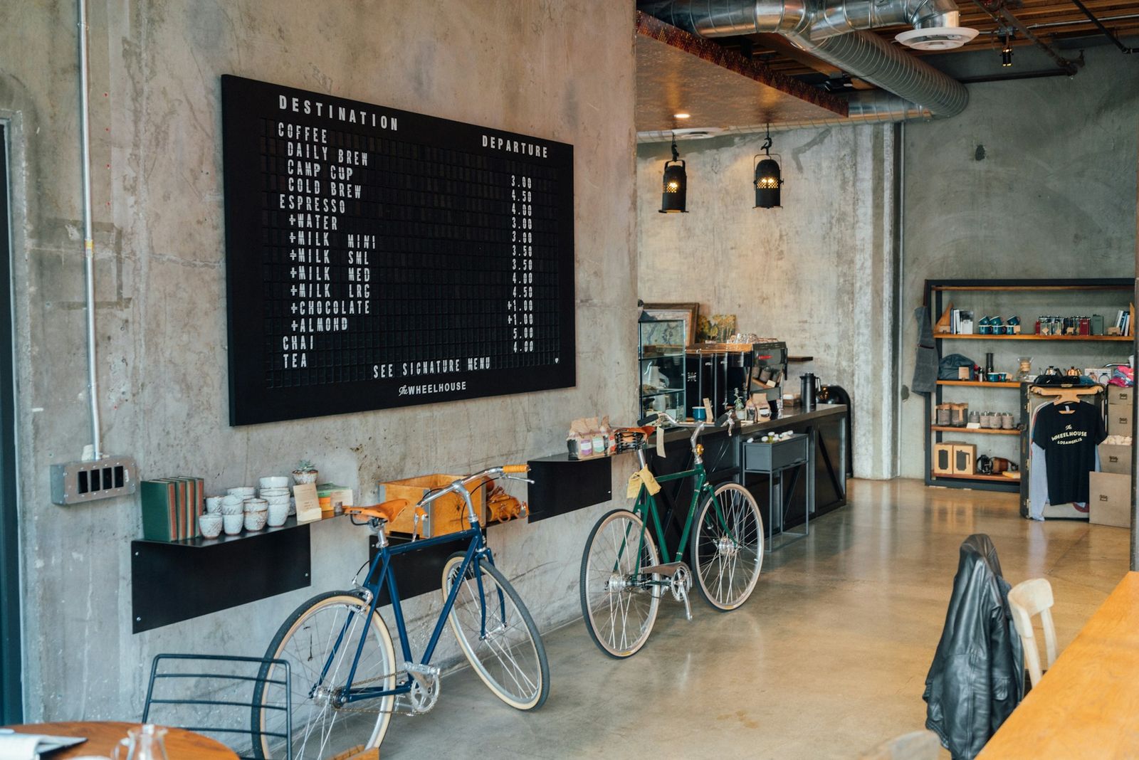 Small cafe interior with wooden tables and natural light. Photo by Jonas Kakaroto on Unsplash.