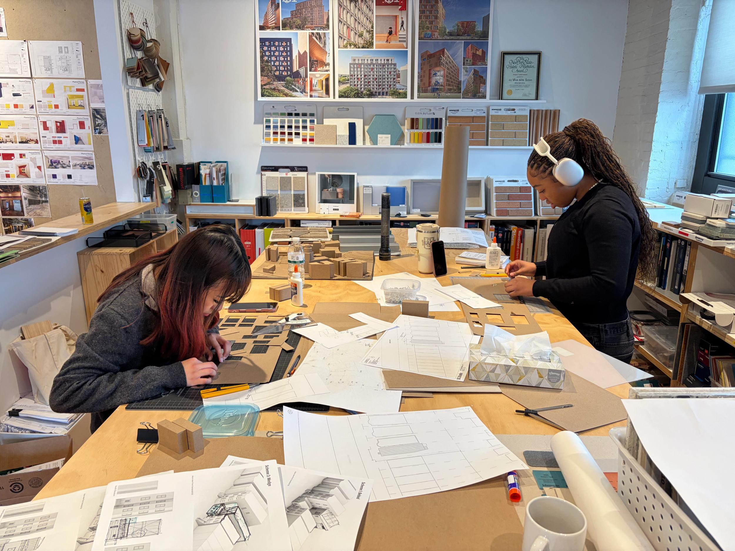 students crafting architectural model