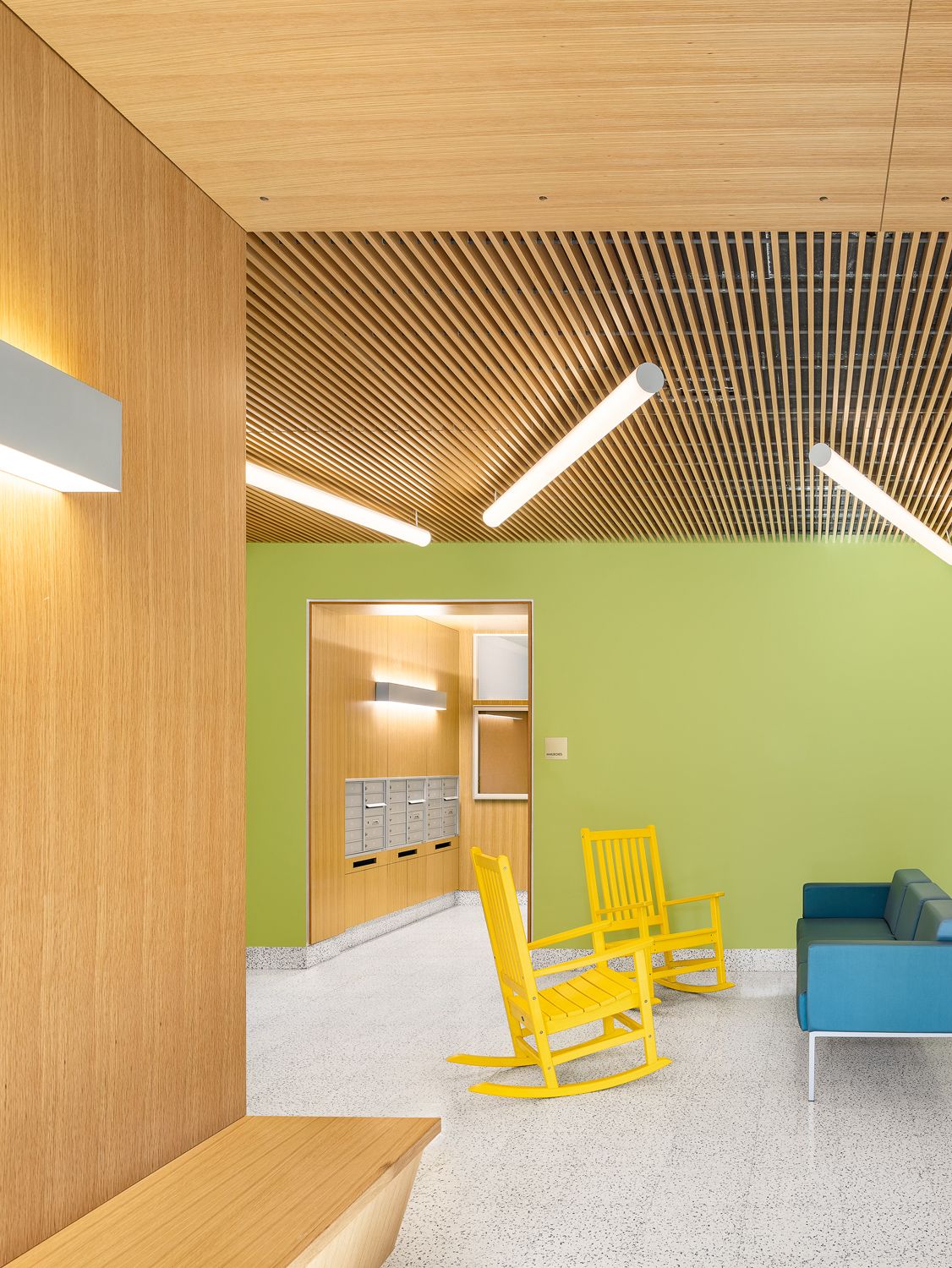 Interior view of residential lobby sitting area and mailboxes at Tres Puentes East