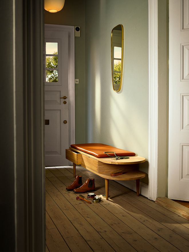 An image of FDB Møbler's F24 Radius bench as part of the hallway decor.