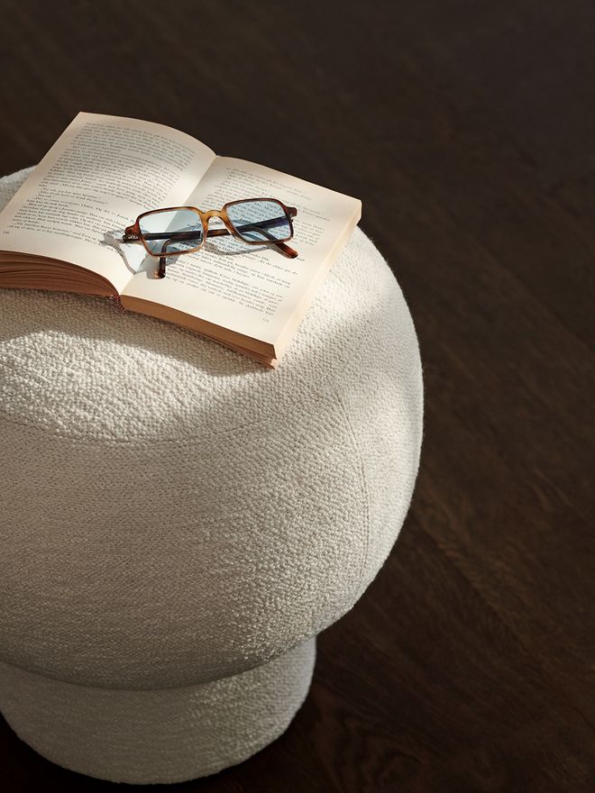 An image of NORR11's Champagne pouf doubling as a side table.