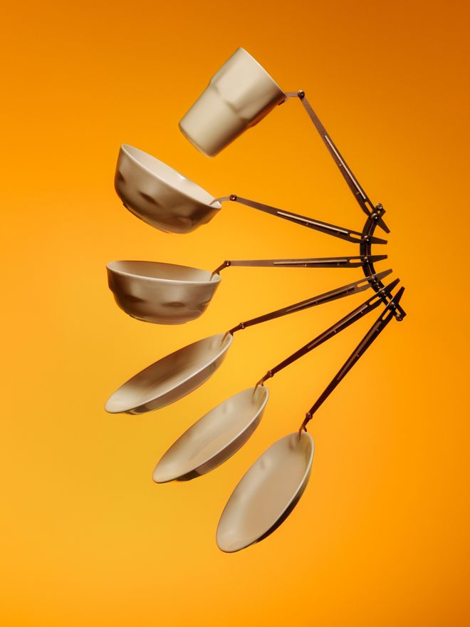 Iittala’s white Solare plates photographed against an orange background