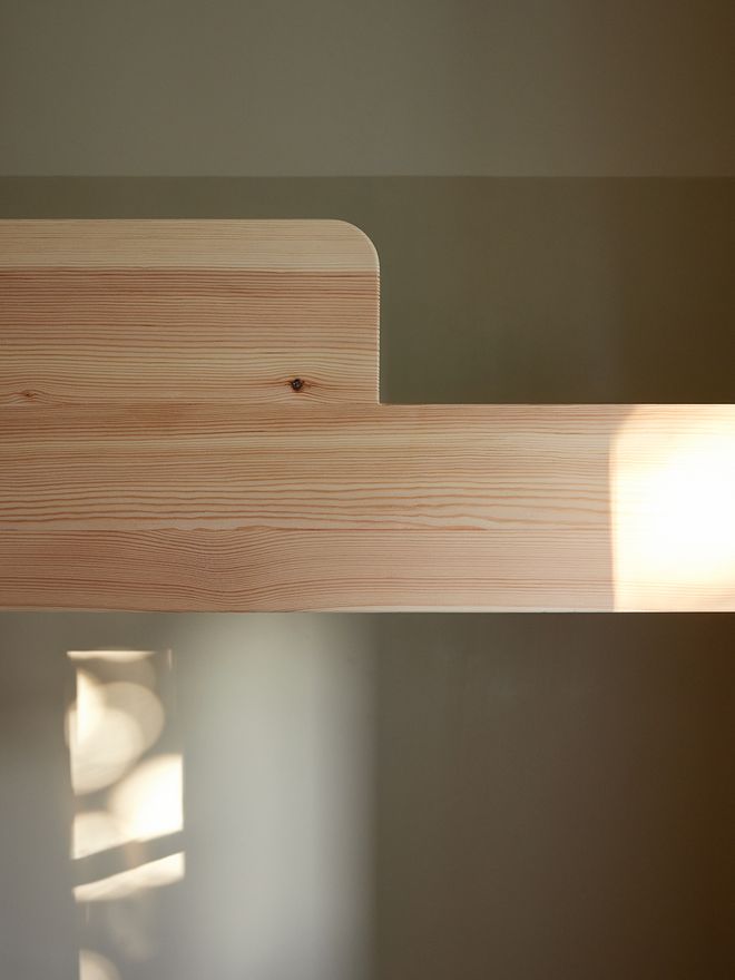 A detail of a pine wood bed frame
