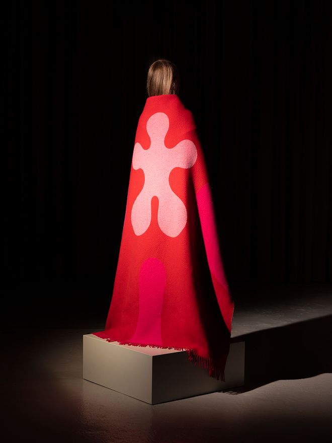 A woman wearing the Teenager from Mars blanket
