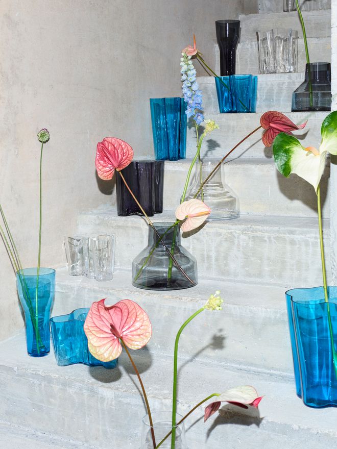 Iittala Solare and Aalto vases with flowers on grey steps