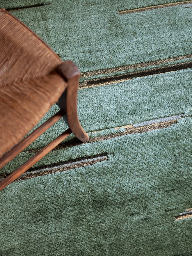 Nanimarquina Colorado rug by Inga Sempé with sage green tones and woven border detail