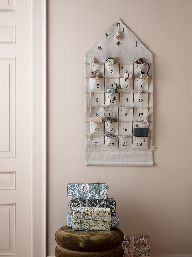 An image of ferm LIVING's Star Christmas calendar hung on the wall, as part of a festive decor.