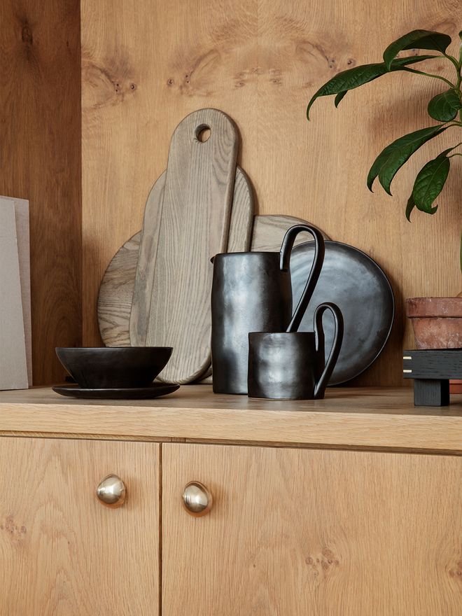 Ferm Living's Mushroom hooks as pulls on a cabinet.
