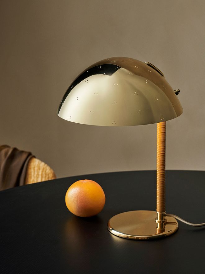 An image featuring GUBI's Paavo Tynell's 9209 table lamp as part of the living room interior.