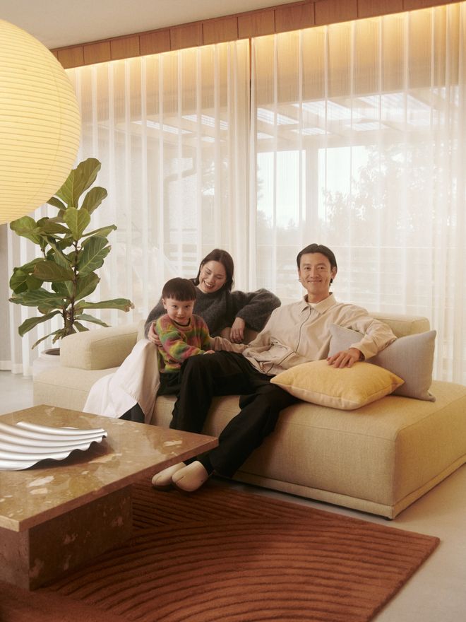Lian, Adeline, and Wai in their living room