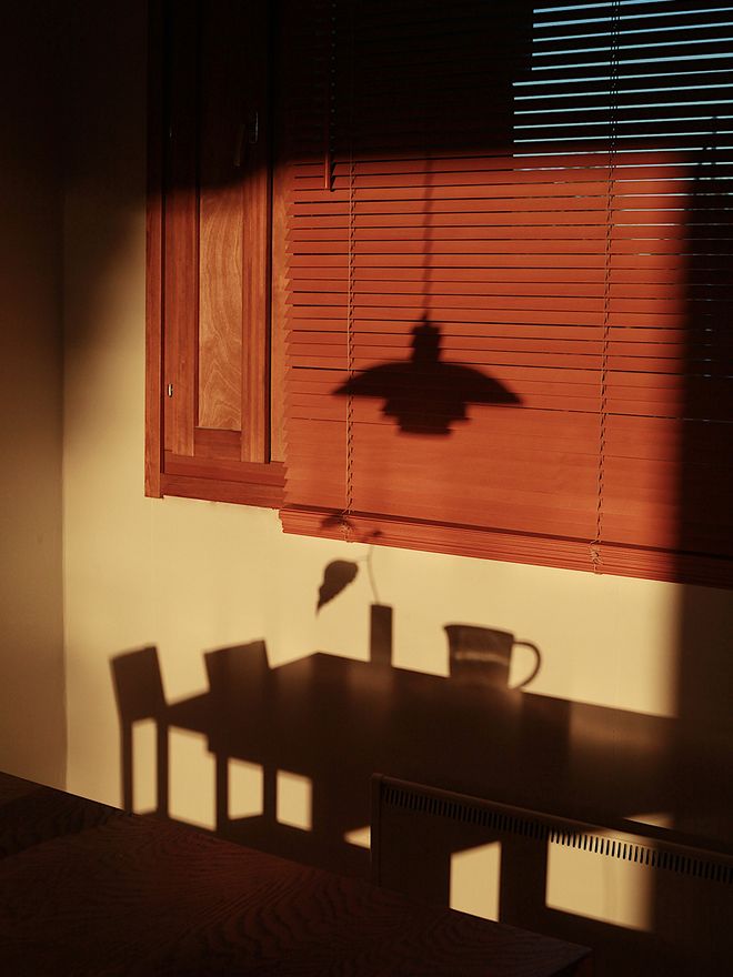 A shadow of a table and a lamp.