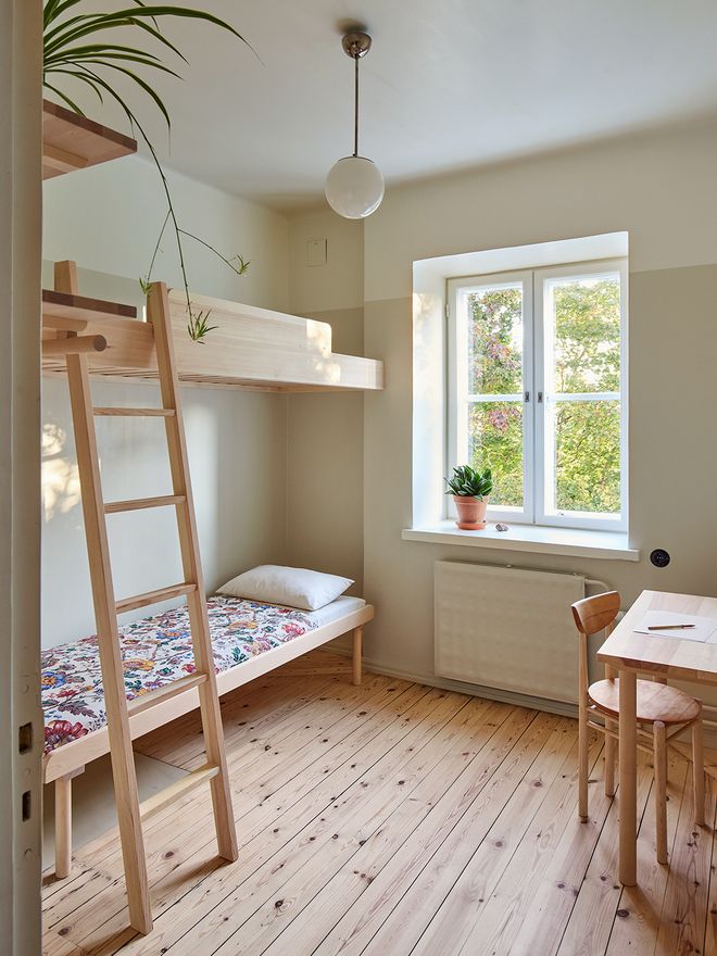 A small bedroom with a loft bed