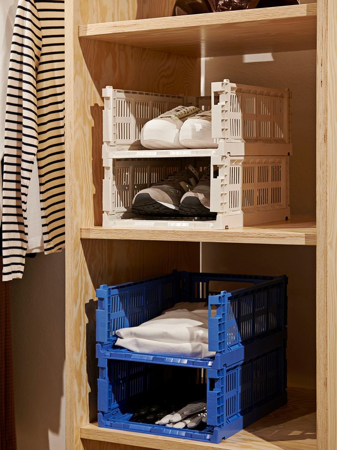 An image of HAY's Colour Crates in a cupboard, as part of the hallway or walk-in closet decor.