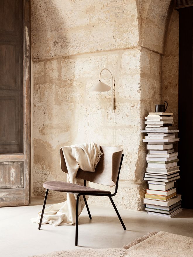 Ferm Living's Arum wall lamp in a living room.