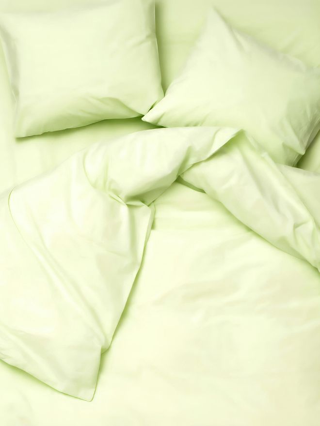 A close-up of lime green bed linen