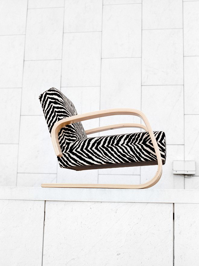 An image featuring Artek's armchair 400 or 'Tank' in a zebra -patterned fabric.