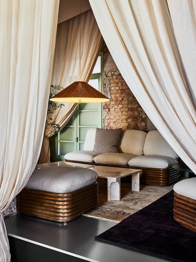 An image featuring GUBI's Paavo Tynell's lamps as part of the living room interior.