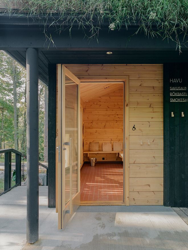 Exterior view of the Kuusijärvi smoke sauna in Vantaa, with the door open