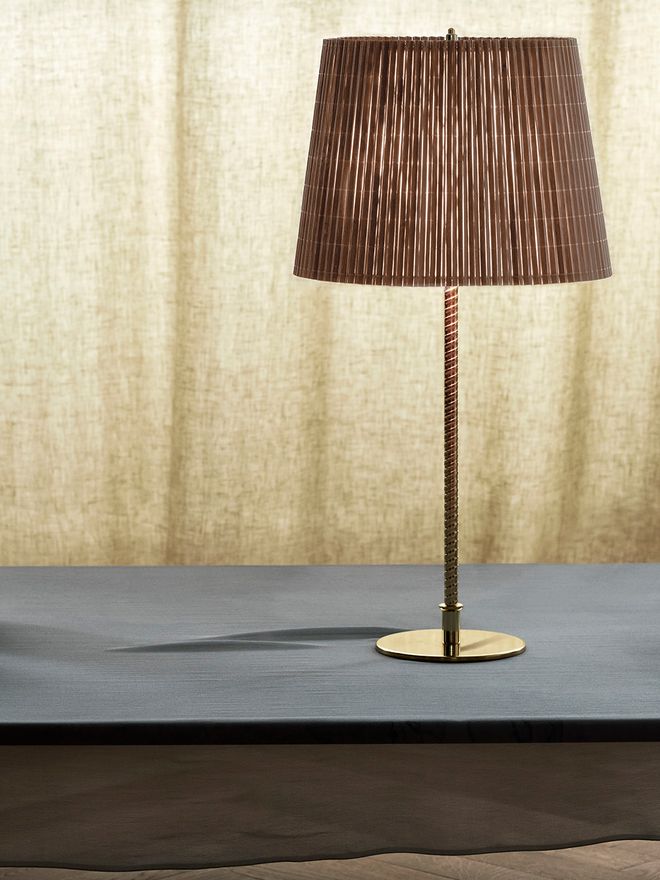 An image featuring GUBI's Paavo Tynell's 9205 table lamp as part of the living room interior.