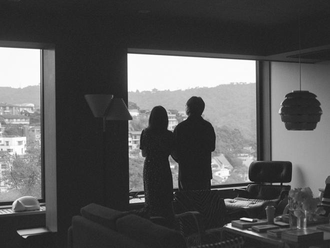 Black and white image of a couple looking outside