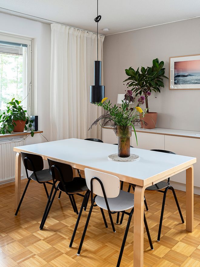 A black A110 pendant lamp over a dining table