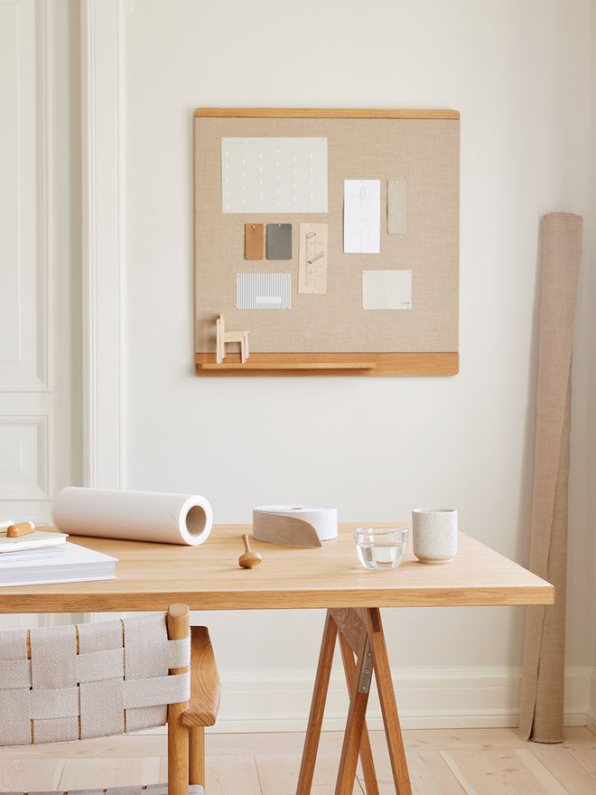An image of Form & Refine's Rim pinboard in oak and cotton canvas, attached to the wall.