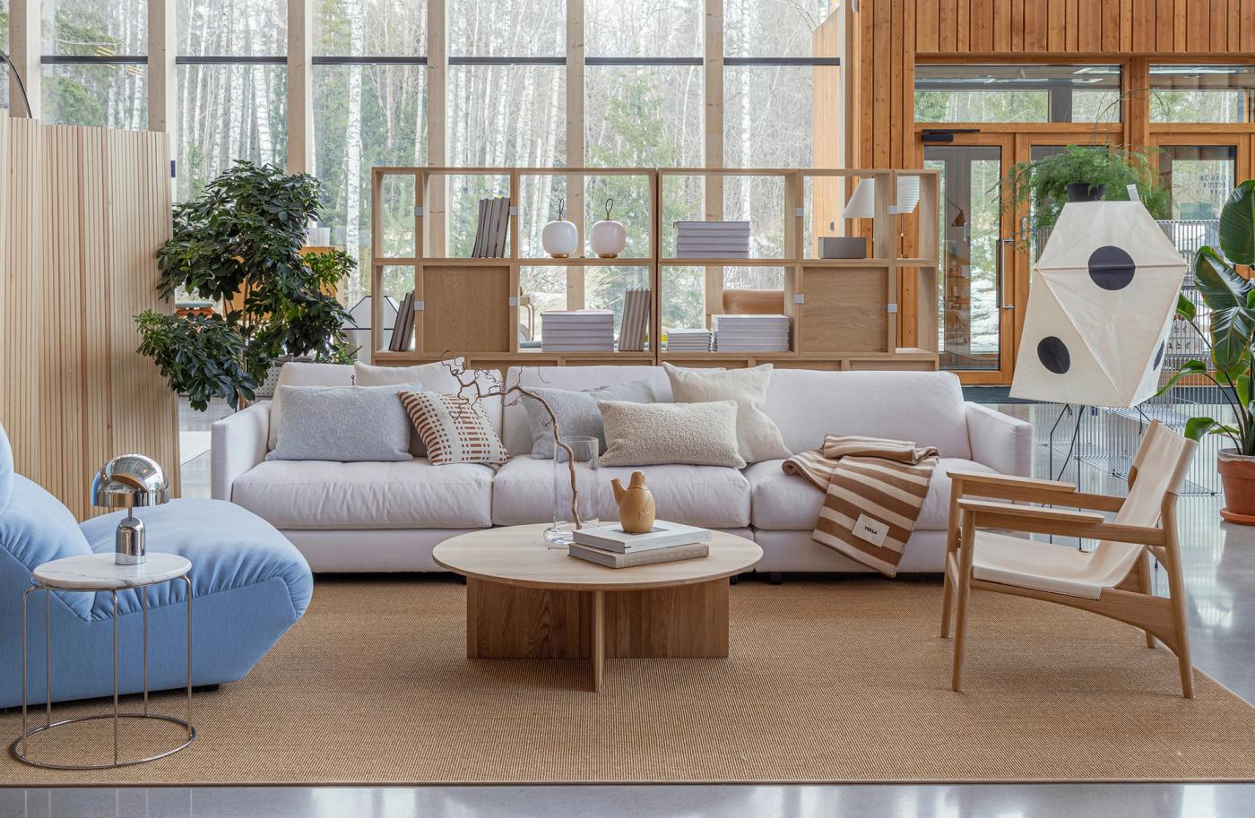 A white sofa, wooden sofa table and chairs