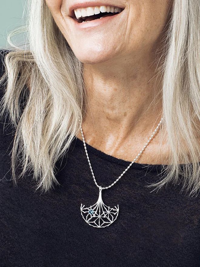 Voice of Woman necklace worn by a model.