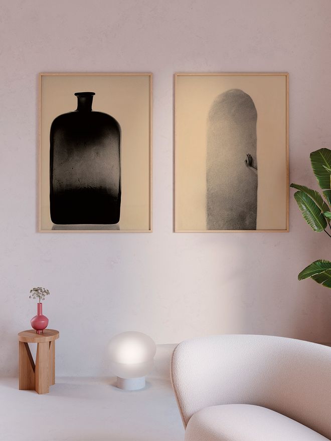 An image of Mikael Siiriläs The Botlle and Hand and Wall art posters hung on the wall.