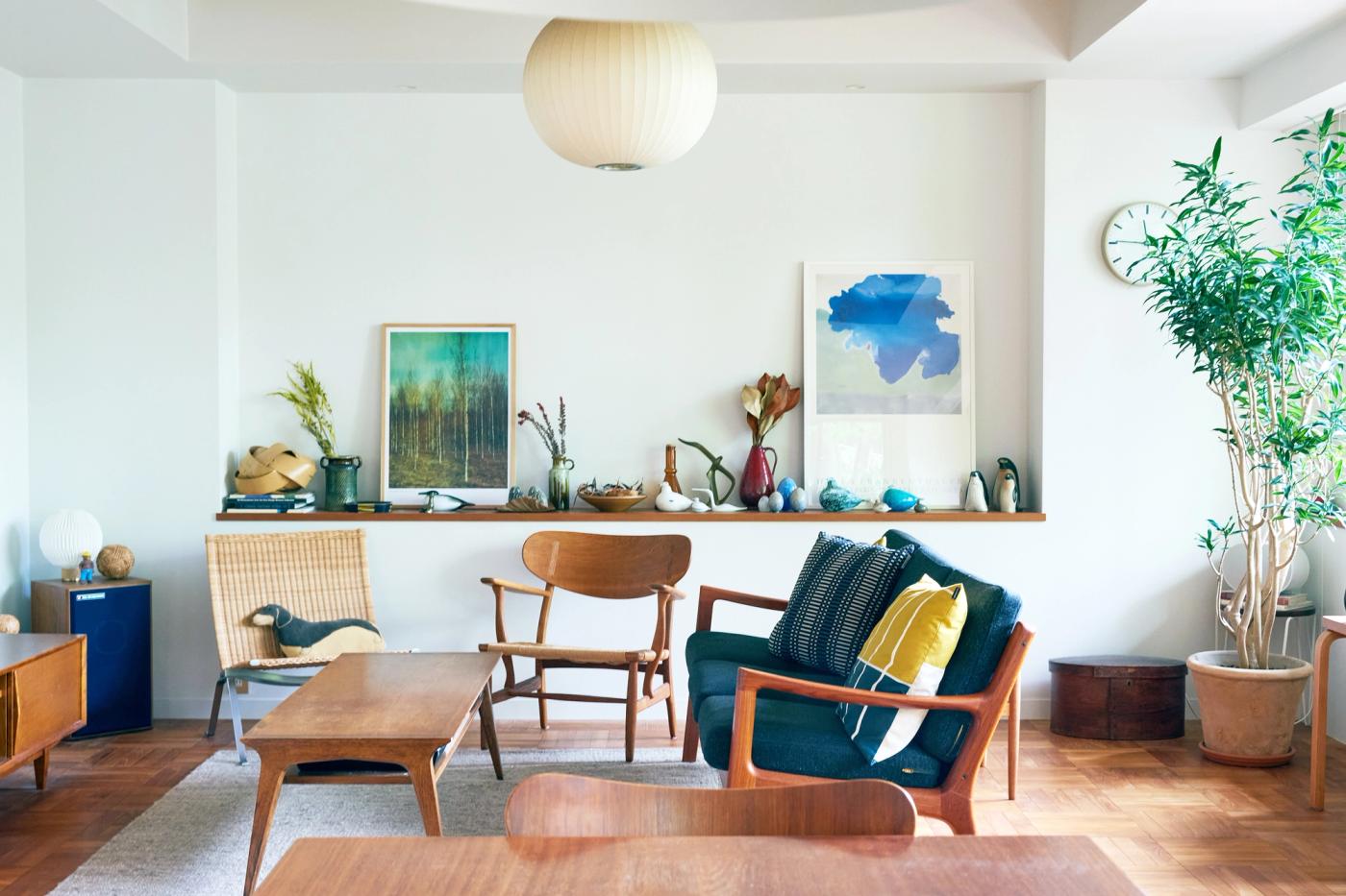 A view of a living room with lota of art and vintage ceramics