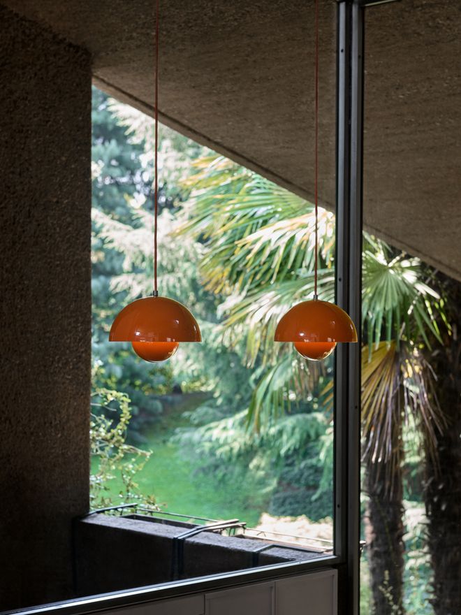 Two bright orange Flowerpot pendants hanging on the ceiling
