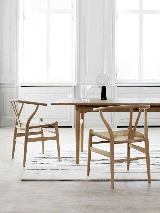 Carl Hansen & Søn's Wishbone chairs in soaped beech and natural paper cord, placed around a dining table