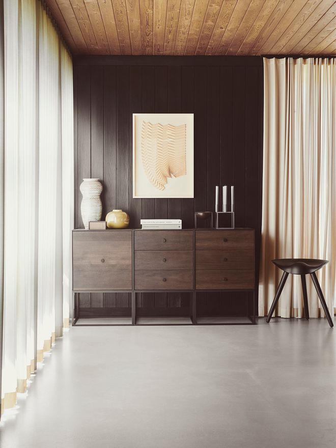 An image featuring by Lassen's Frame storage furniture and the ML42 stool as part of the living room or bedroom decor.