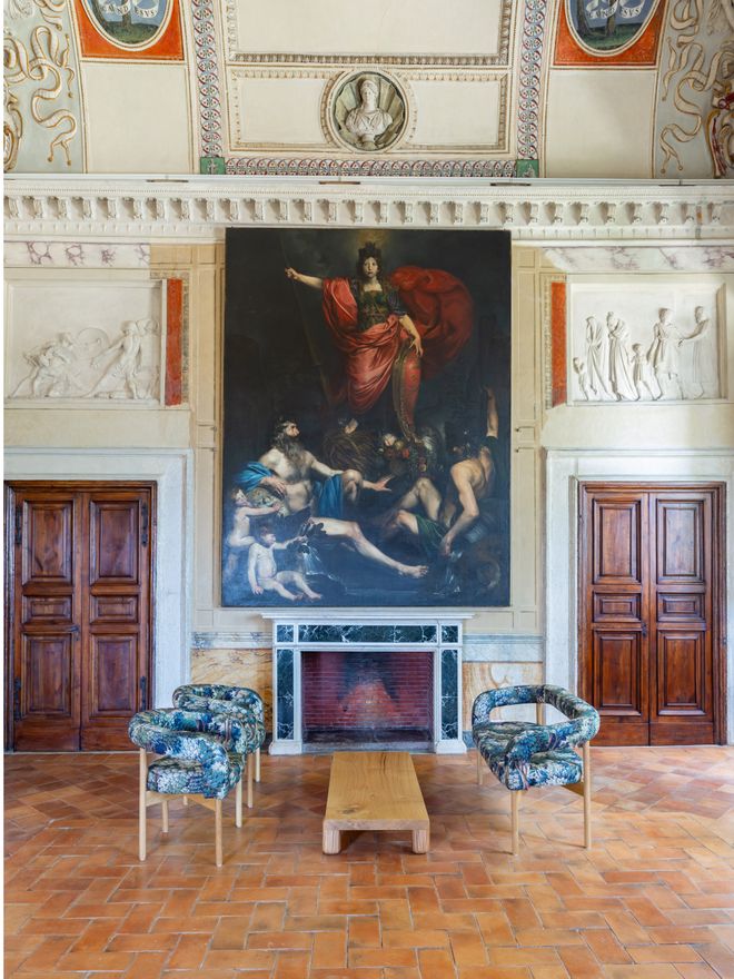 Interior of the Salone with a large oil painting on the wall and a minimalist coffee table