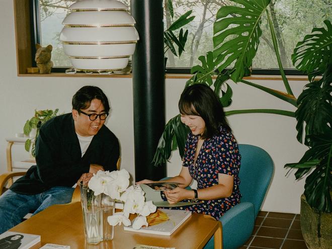 Egg 2 and Dora, sitting and smiling in their living room
