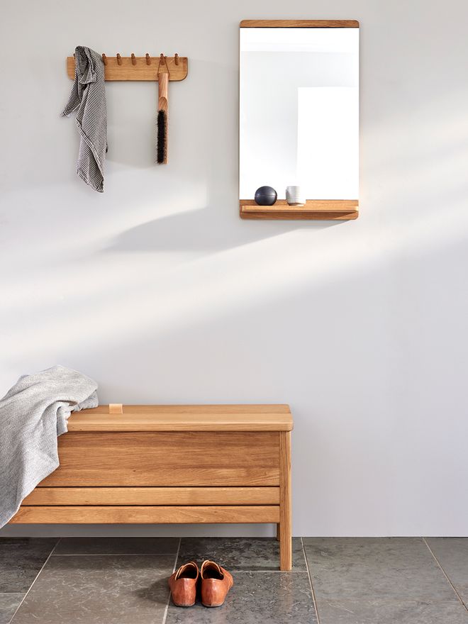 An image of Form & Refine's A Line storage bench, Echo rack and Rim mirror as part of the bathroom decor.