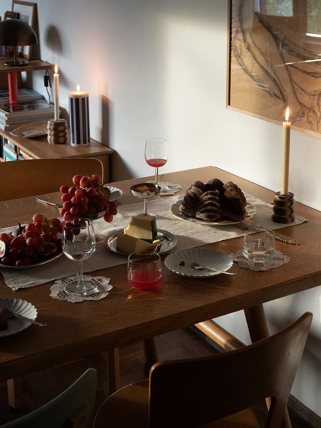 A holiday table with candles and cakes