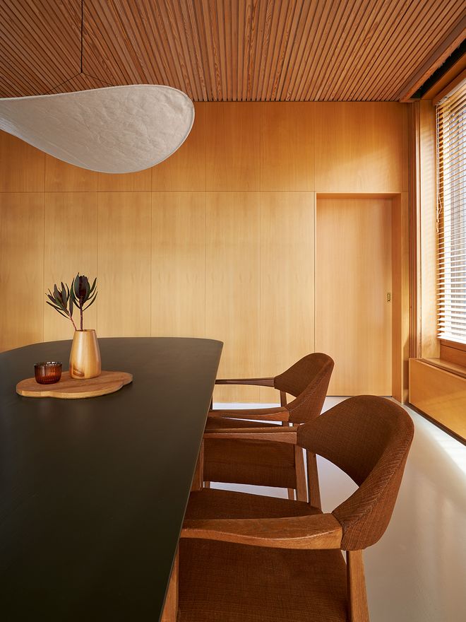 Two vintage chairs next to a dining table