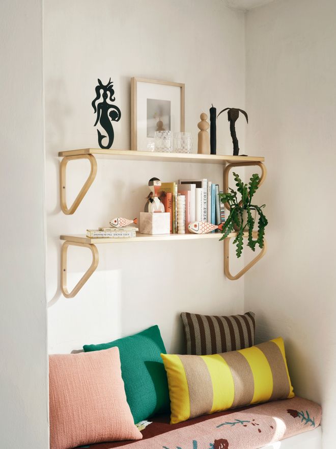 Colorful cushions and Aalto wall shelves