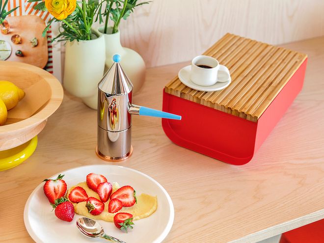An image of Alessi's red Mattina breadbox as part of the kitchen decor.
