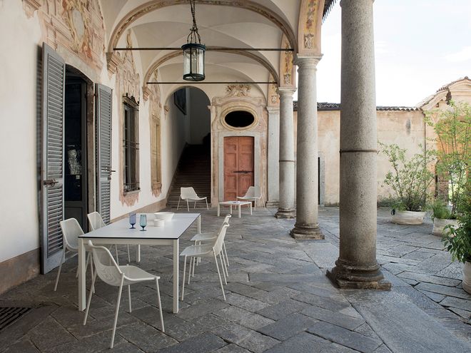 Emu's Round chairs on a patio, gathered around a dining table.