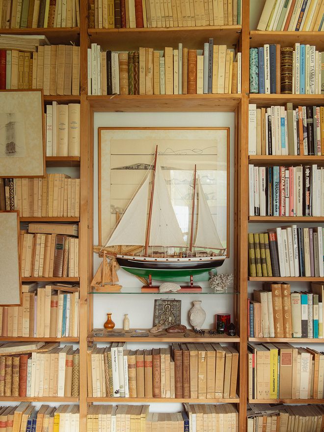 Bookshelves in Villa Skeppet's study, with a scale model of the Schildts' sailboat Daphne, a framed nautical illustration, and maritime decorative objects
