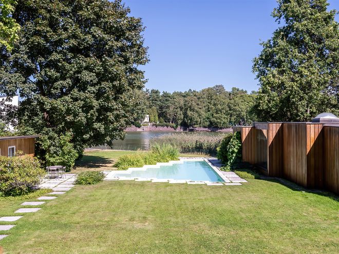 An image featuring Villa Ervi designed by architect Aarne Ervi. The photo shows the yard and the exterior of the office building.
