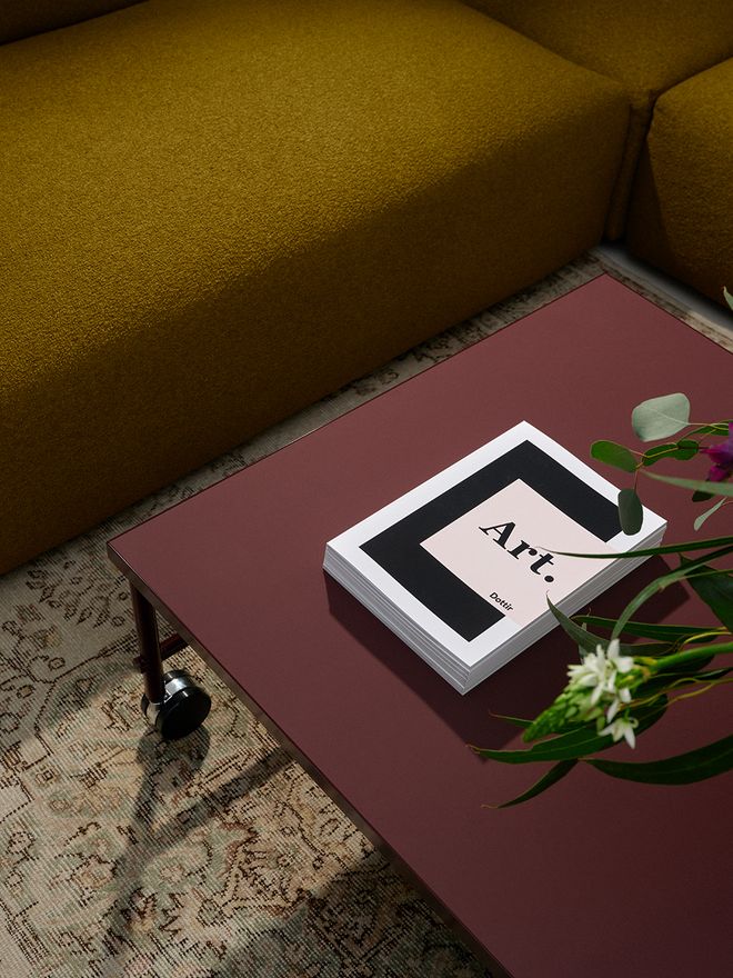 A detail of a dark red coffee table
