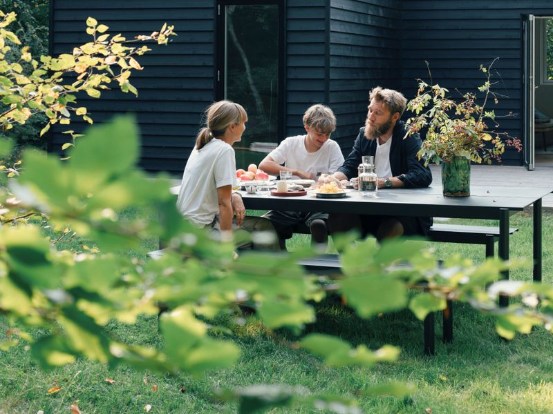 The Karstad family around an outdoor dining table