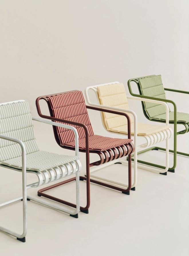 Close-up of four HAY Palissade Cantilever chairs in different colors, topped with stylish striped seat cushions