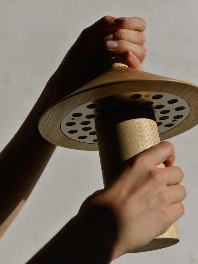 Hands holding the Astep Pepa lamp
